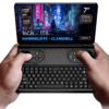 Ruke drže GPD Win Mini 2025, kompaktno ručno računalo s preklopom s 7-inčnim 120Hz VRR zaslonom, AMD Ryzen 7 8840U procesorom, AMD Radeon grafikom, 16GB RAM-a i 1TB NVMe memorije, prikazanim na futurističkoj cyberpunk pozadini.