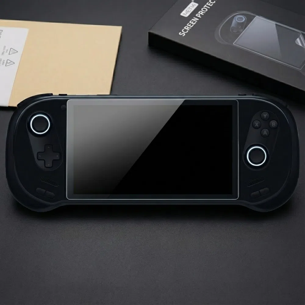 A black AYANEO 3 handheld gaming console lies centered on a dark surface, featuring a newly applied tempered glass screen protector. The console's dual joysticks are illuminated with circular white LED rings. To the top right, the product packaging is visible, showing a black box labeled "METIK SCREEN PROTECTOR" with an illustrative diagram of the installation process. The sleek, matte black finish of the device and the glossy reflection on the protected screen create a high-end, tech-focused aesthetic.