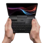 The GPD MicroPC 2 being held in both hands, showcasing its compact 7-inch touchscreen, rugged industrial design, and thumb-typing-friendly keyboard for IT professionals and field engineers