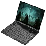 A black GPD WIN MAX 2 handheld gaming PC is shown open at an angle, displaying a dark fantasy action game on its screen. The device features a full QWERTY keyboard, an integrated touchpad, and game controllers with analog sticks and buttons on either side of the keyboard.