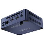 An angled view from the bottom and back of the dark blue Beelink Mini S12 mini PC against a white background. This perspective highlights the various rear ports, including multiple USB-A ports, an Ethernet port (LAN), two HDMI ports, and a DC power input. The bottom of the device shows regulatory marks and the text "MADE IN CHINA", along with a "Quick Swapping Button Description".