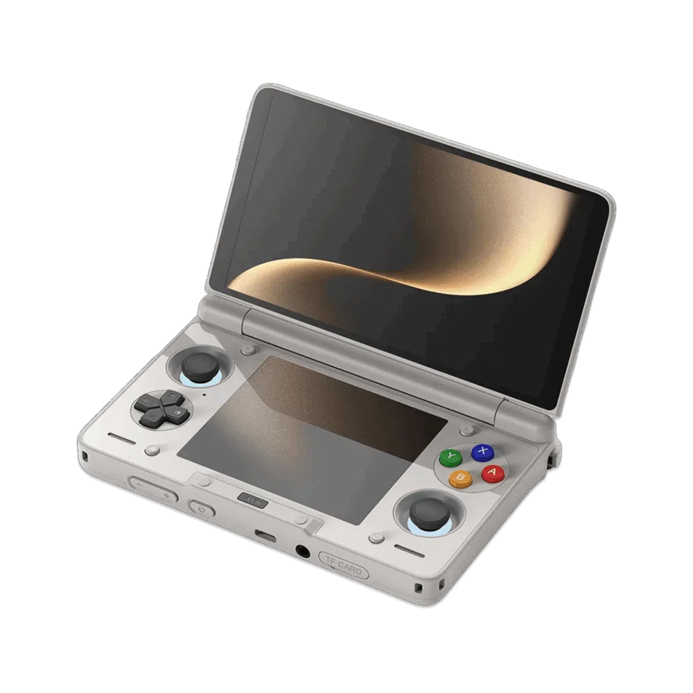 An angled, open view of a light grey AYN Thor handheld gaming console with a clamshell design, against a dark, featureless background. The top screen is open, displaying a soft golden abstract image. The bottom half of the device shows the controls, including a black D-pad, black analog sticks, and face buttons in red, blue, green, and yellow, resembling the classic "rainbow" controller aesthetic. Both the top and bottom screens are reflective, mirroring the golden light.