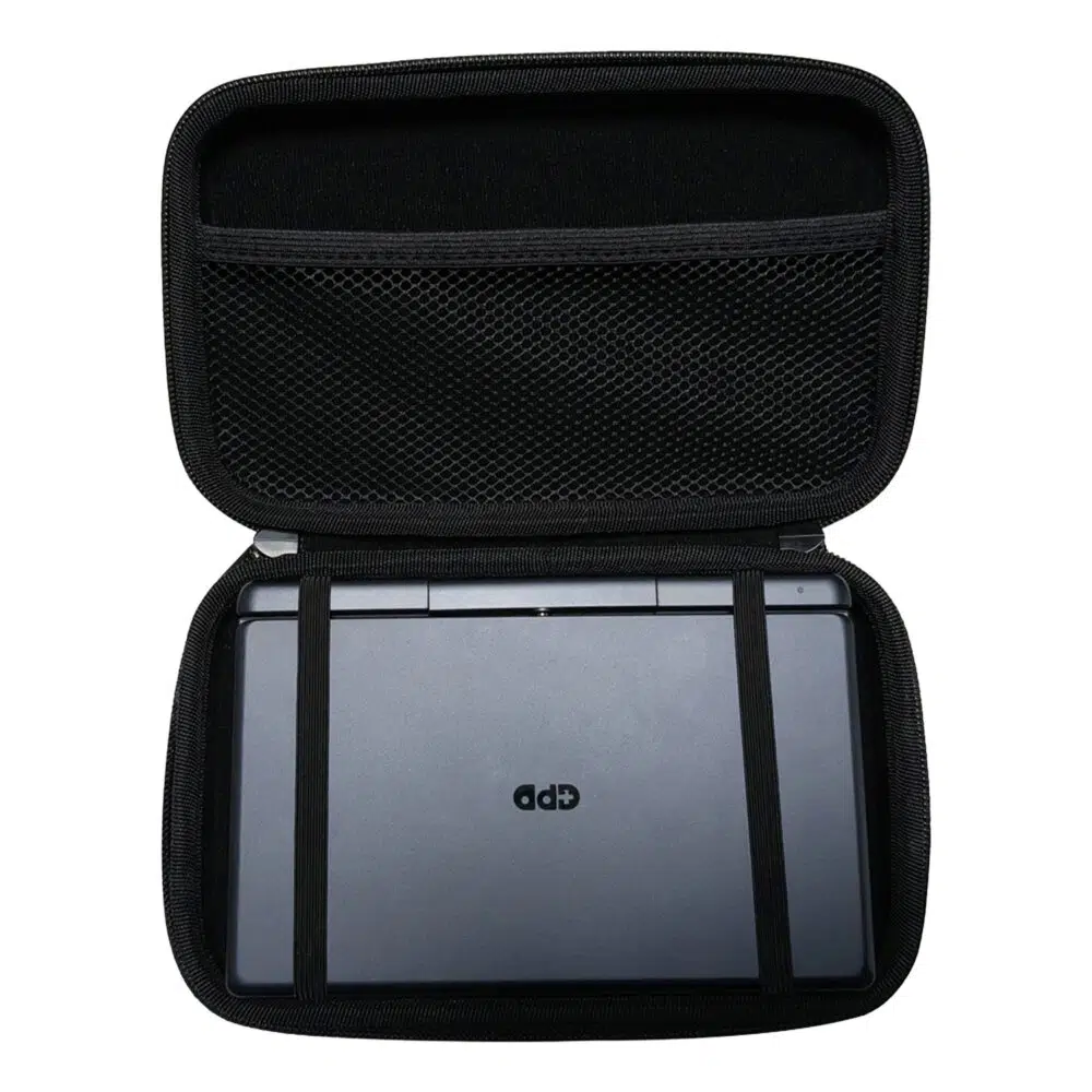 A top-down shot of the open, black hard shell case for the GPD MicroPC 2. A grey GPD MicroPC 2 is secured inside the bottom half with two black elastic straps. The top half of the case has a mesh pocket. The front of the MicroPC 2 is facing upwards, showing the "GPD" logo.