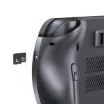 A close-up, angled shot of the back of a dark grey GPD WIN 5 handheld gaming console against a plain white background. The image focuses on the microSD card slot, which has a 2TB microSD card being partially inserted into it. The textured back grip and the "R4" shoulder button are also visible.