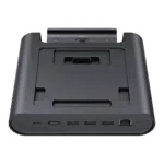 A three-quarter frontal view of a black GPD WIN 5 docking station, isolated against a black background. The dock features an array of ports on the front edge, including USB-C, USB-A, and an RJ45 Ethernet port. The recessed top area is designed to hold the GPD WIN 5 and includes a connector for charging and data.