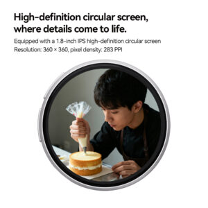 Close-up of a circular smart badge featuring a high-definition IPS screen. The screen displays a clear, detailed image of a person meticulously decorating a cake with frosting. Text above specifies a 1.8-inch screen size, $360 \times 360$ resolution, and 283 PPI.