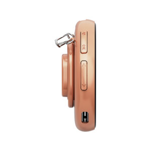 A side view of the rose gold/copper-colored NIKKO Badge TS device, isolated against a white background. The side panel shows control buttons, including an up/down slider, an OK button, and a USB-C port at the bottom. The top features a lanyard loop attached to the device's rotating camera/badge module.