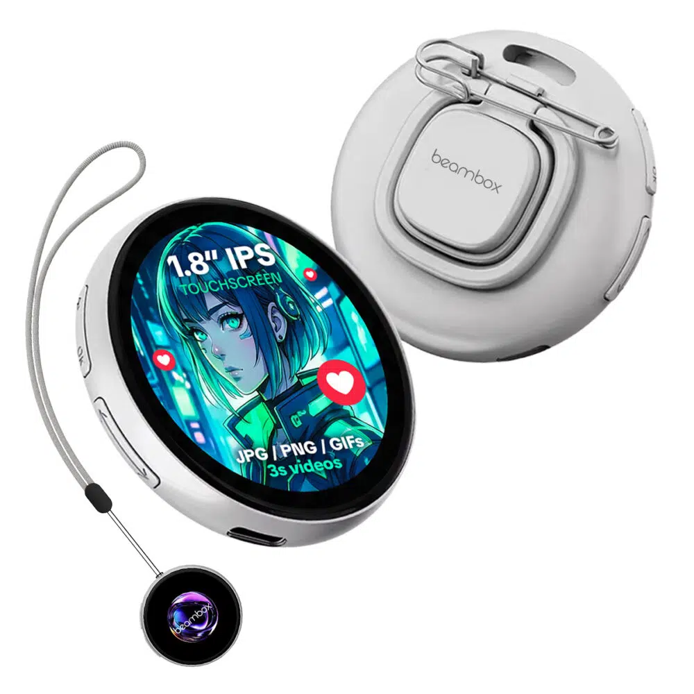 A white electronic badge with a round screen showing a blue, green, and red anime-style girl is shown. The screen displays text that reads "1.8” IPS TOUCHSCREEN" and "JPG / PNG / GIFS 3S videos" with small red heart icons to its side. A metal clip is attached to the back of the device. The device is hanging on a gray string attached to another smaller round device that is black with a glowing blue, purple, and green pattern in the center. The overall shape and color of the devices are reminiscent of round watches.
