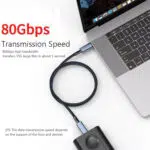 Poudarek: Hitrost prenosa podatkov 80 Gb/s Vizualno: Pogled od zgoraj navzdol na kabel, ki povezuje prenosni računalnik z zunanjim trdim diskom/SSD. Ključne informacije: Velik rdeč napis 80 Gb/s in trditev, da lahko prenese 15 GB datoteko v približno 1 sekundi. 