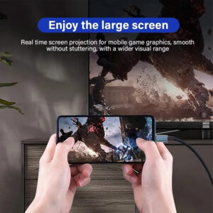 A lifestyle image titled "Enjoy the large screen" showing a person holding a smartphone horizontally while playing a high-action video game. The phone is connected via a USB-C cable to a large TV in the background, which mirrors the same game graphics. The text describes "Real time screen projection for mobile game graphics, smooth without stuttering, with a wider visual range".