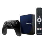 A perspective studio shot of the RockTek G2 Android TV box bundle against a black background. The set includes a square navy blue textured media hub, a black ergonomic game controller with dual joysticks, and a slim black remote control featuring dedicated buttons for YouTube, Netflix, Prime Video, and Disney+.