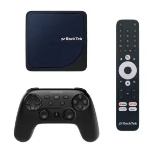 A top-down, flat-lay arrangement of the RockTek G2 streaming kit on a white background. Shown are the navy blue leather-textured TV box, a matte black wireless game controller with a central Google Assistant button, and a full-sized numeric remote control with a white circular navigation pad.