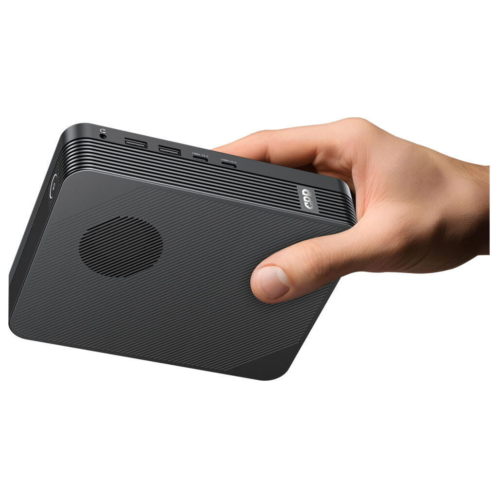GPD BOX Mini PC 4 A person's hand holds the matte black GPD unit horizontally against a white background, highlighting its small, handheld form factor. The side profile clearly shows the headphone jack, dual USB-A ports, and dual USB4 V2.0 ports.