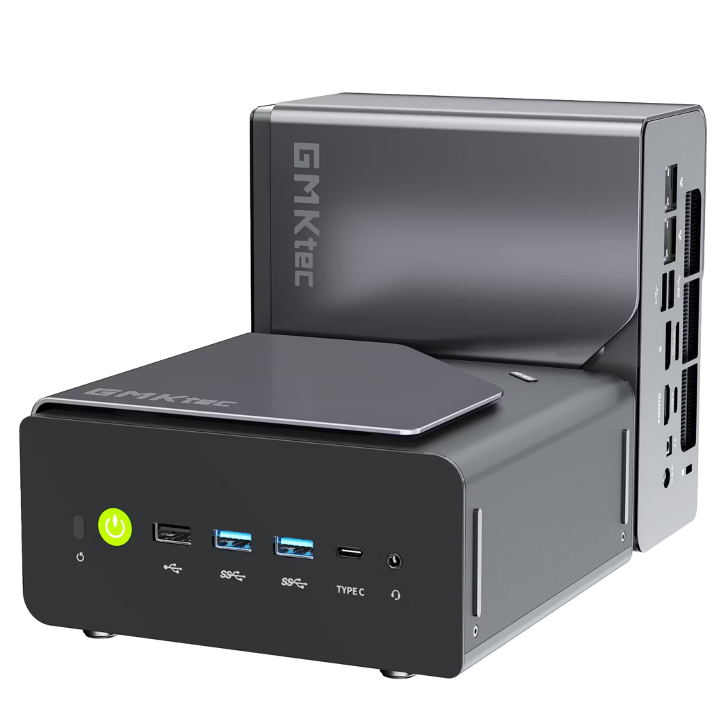 A product shot showing two identical compact mini PCs on a solid black background. One unit sits horizontally in the foreground, displaying its front panel with a glowing green power button, three USB-A ports, a Type-C port, and a headphone jack. The second unit is placed vertically directly behind it, showcasing its sleek gray side panel with the "GMKtec" logo and a view of the rear I/O connectivity ports.