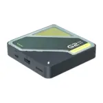 Angled RockTek G2 Next Google TV box, matte dark gray with translucent top, yellow striped panel, USB-C and HDMI ports